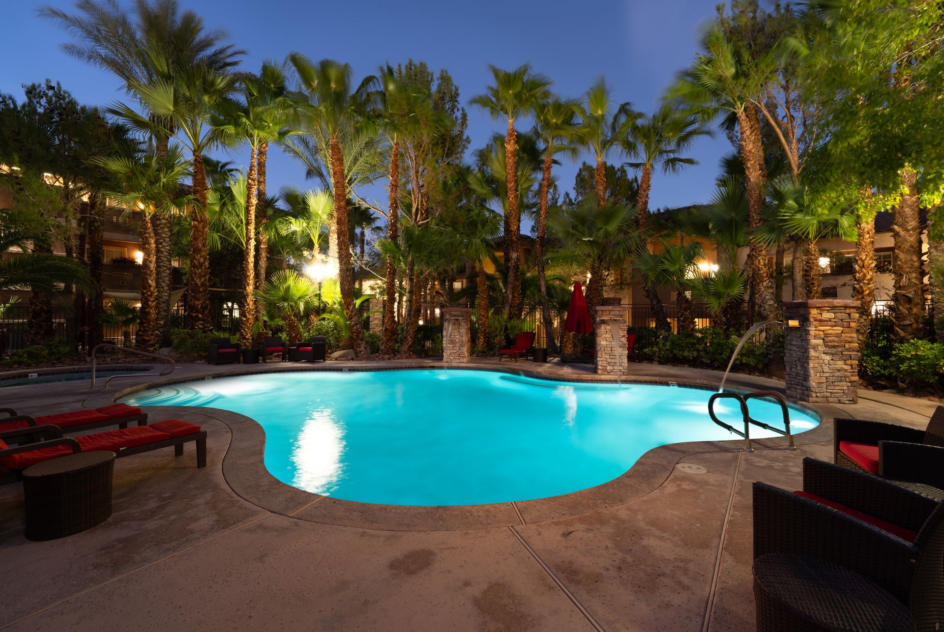 Heated pool at dusk surrounded by palm trees at The Willows in Las Vegas