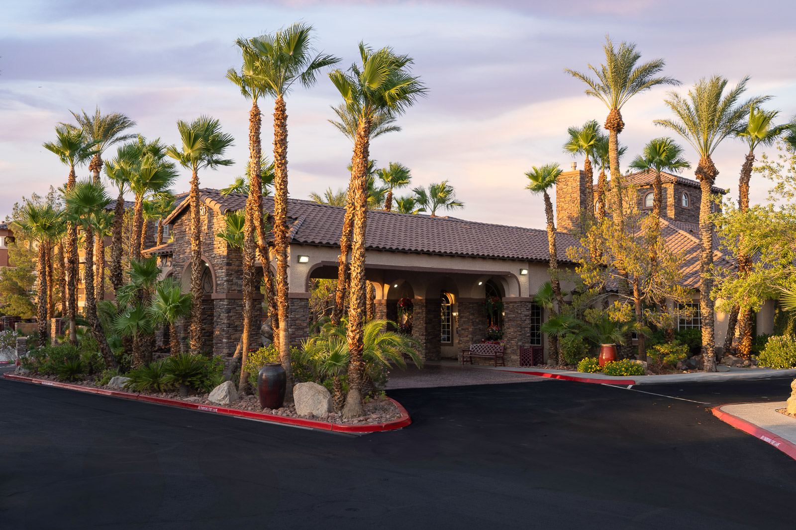 Palm-lined entrance to the clubhouse at Carefree Senior Living at The Willows in Las Vegas